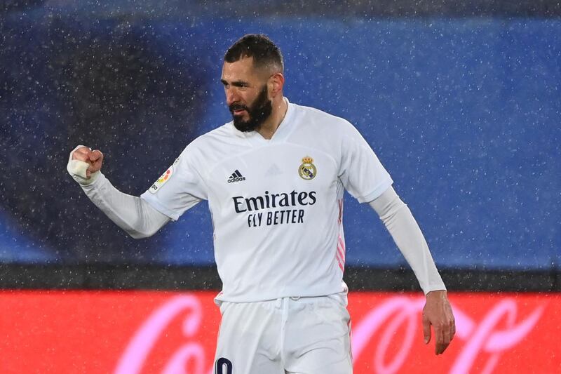 Real Madrid's French forward Karim Benzema celebrates after scoring a goal during the Spanish league football match between Real Madrid CF and Getafe CF at the Alfredo di Stefano stadium in Valdebebas, on the outskirts of Madrid on February 9, 2021. / AFP / GABRIEL BOUYS
