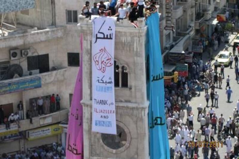 In this citizen journalism image provided by Shaam News Network, Syrian anti-government protesters hang a banner in Arabic that reads:" thank you Al-Jazeera and Shaam News Network," during a rally in the central city of Hama, Syria, Friday, July 15, 2011. Syrian security forces fired on protesters in the capital and other major cities Friday, killing at least 14 people as hundreds of thousands gathered for some of the largest anti-government rallies since the uprising began in March, witnesses and activists said. (AP Photo/Shaam News Network) EDITORIAL USE ONLY, NO SALES, THE ASSOCIATED PRESS IS UNABLE TO INDEPENDENTLY VERIFY THE AUTHENTICITY, CONTENT, LOCATION OR DATE OF THIS HANDOUT PHOTO *** Local Caption ***  Mideast Syria.JPEG-0b339.jpg
