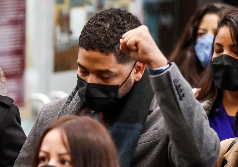 Smollett raises his fist as he enters the Leighton Criminal Courthouse for the fifth day of his trial on December 6. EPA