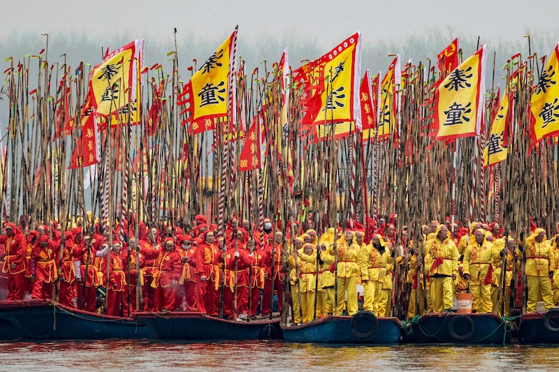 Participants stand on traditional boats during the Taizhou Jiangyan Qintong Boat Festival in Jiangsu province, eastern China. AFP
