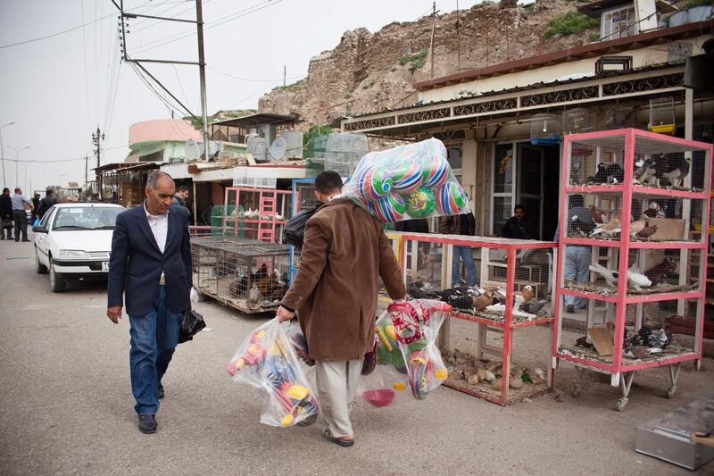 KIRKUK, IRAQ: Pedestrians walk past a stall selling pigeons in the bazaar in Kirkuk.

Kirkuk is an ethnically diverse city in which there is often tension and outbreaks of violence.

Photo by Ali Arkady/Metrography