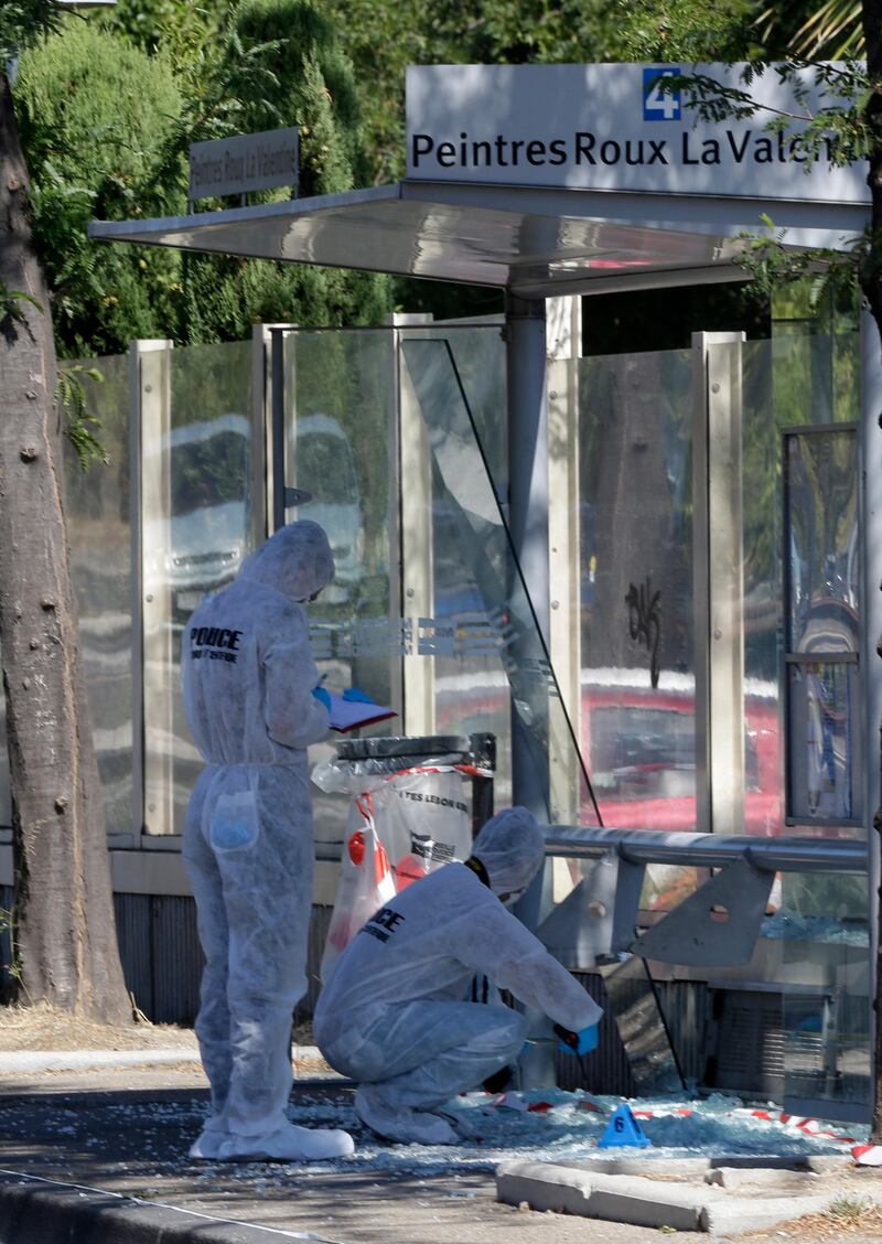 Police officers inspect a bus stop in La Valentine district after a van rammed into two bus stops in the French port city of Marseille, southern France. Claude Paris / AP Photo