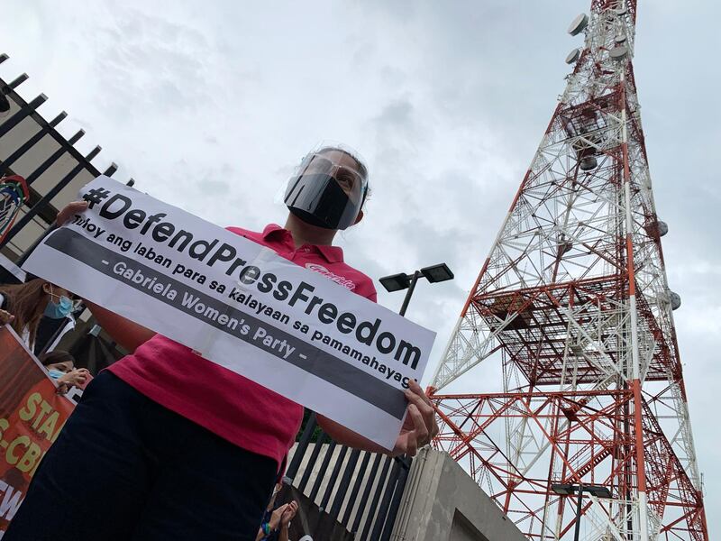 A Filipina holds a placard as she joins a demonstration outside the ABS-CBN network headquarters in Quezon City, Metro Manila, Philippines. EPA