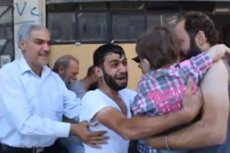 In this screen grab of a YouTube video, a Syrian father reacts with joy and shock as he is reunited with his son who he had thought had died in the August 21 chemical attack in Damascus.