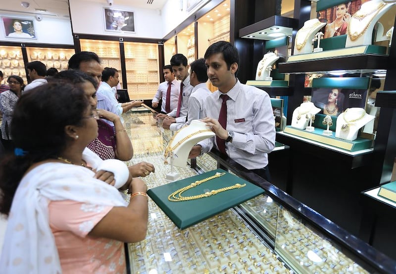 Customers shop for gold jewellery at a Malabar store in Abu Dhabi. Ravindranath K / The National