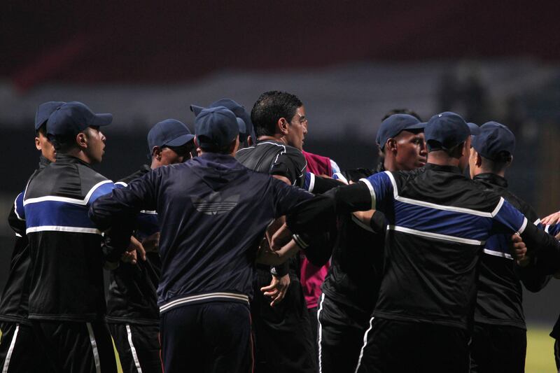 Referee Ibrahim Noor El Din reacts while being surrounded by security guards during the Arab Club Championship final between Esperance de Tunis and Jordan's Al Faisaly in Alexandria, Egypt, late on Sunday night. Mohamed Hossam / EPA