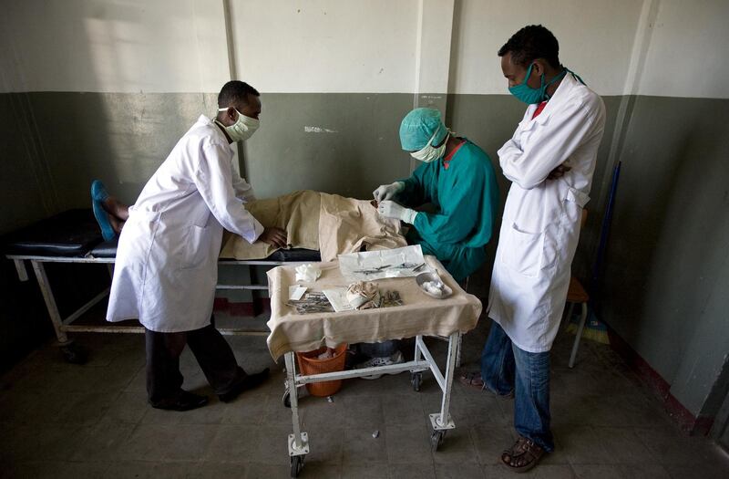 Arsi Negele - November 13, 2008:   A doctor performs eye surgery on a female patient while two attending nurses assist at the Arsi Negele Health Center in Arsi Negele, Ethiopia, November, 13, 2008.  (Jeff Topping/The National) *** Local Caption ***  JT021-1113-ORBIS IMG_9527.jpgJT021-1113-ORBIS IMG_9527.jpg