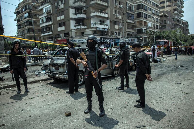 FILE -- In this June 29, 2015 file photo, Egyptian policemen stand guard at the site of a bombing that killed Egypt's top prosecutor, Hisham Barakat, who oversaw cases against thousands of Islamists, in Cairo. On Wednesday, Feb. 20, 2019 Egypt executed nine suspected Muslim Brotherhood members convicted of involvement in the 2015 assassination of Barakat, security officials said. The nine were found guilty of taking part in the bombing that killed Barakat, the first assassination of a senior official in Egypt in a quarter century. (AP Photo/Eman Helal, File)