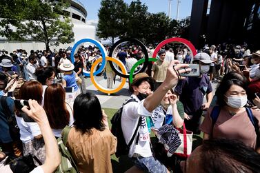 People crowd around the Olympic Rings monument near the Olympic Stadium in Tokyo, Japan July 23, 2021.  REUTERS / Naoki Ogura