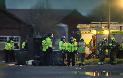 Emergency services attend the scene after a fire broke out at Napier Barracks where asylum seekers are housed in Folkestone, southern England, Friday Jan. 29, 2021.  Emergency services attended the incident after a fire broke out at the barracks where some hundreds of asylum seekers have been living, a migrant charity has said. (Gareth Fuller/PA via AP)