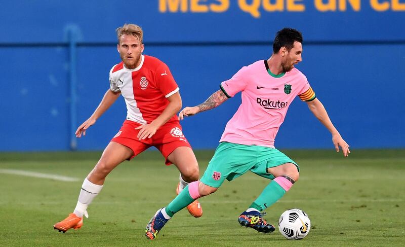 Lionel Messi turns away from Girona's Samu Saiz. Getty