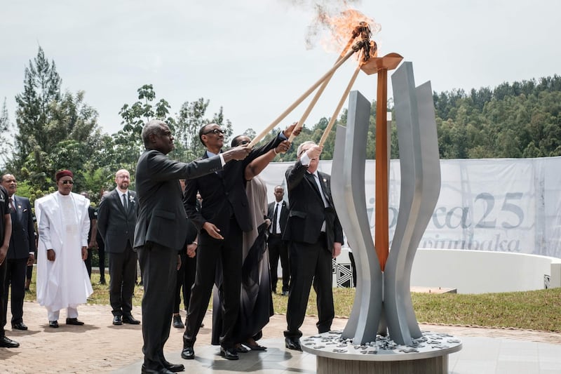 (From L) African Union chief Moussa Faki, Rwanda's President Paul Kagame, his wife Jeannette (2ndR), and European Commission President Jean-Claude Juncker light a remembrance flame for the 25th Commemoration of the 1994 Genocide at the Kigali Genocide Memorial in Kigali, Rwanda, on April 7, 2019. Rwanda on April 7, 2019 began 100 days of mourning for more than 800,000 people slaughtered in a genocide that shocked the world, a quarter of a century on from the day it began. / AFP / Yasuyoshi CHIBA
