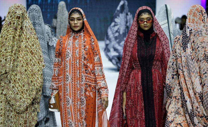 Models display creations by Barli Asmara during the Muslim Fashion Festival in Jakarta, Indonesia. The event was held to greet the upcoming holy fasting month of Ramadan.  AP
