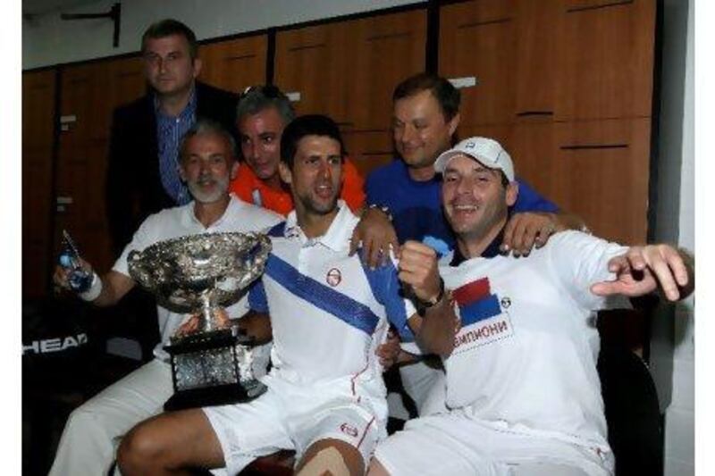 Novak Djokovic celebrates winning the Australian Open last month with his team of coaches, doctor and physicial trainer. Clive Brunskill / Getty Images