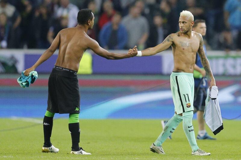 Barcelona’s Neymar, right, and Borussia Monchengladbach’s Raffael greet after exchanging shirts after the Champions League Group C match. Michael Probst / AP Photo