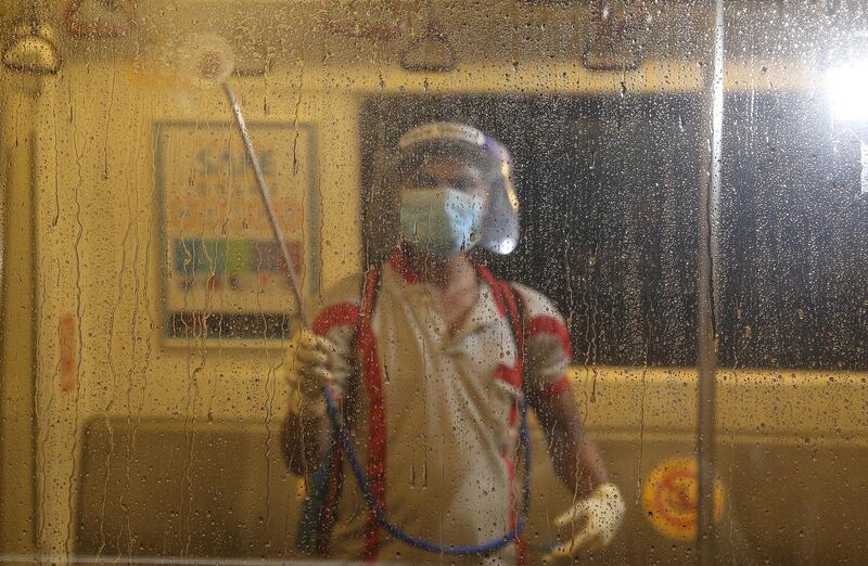 An Indian metro worker sanitises a metro train as a precautionary measure for coronavirus in New Delhi, India. EPA