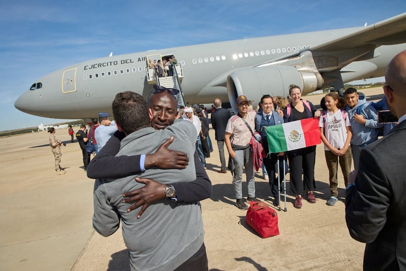 A Sudanese evacuee is embraced after disembarking from a Spanish Air and Space Force plane at Torrejon de Ardoz Airbase, Spain, on April 24.  Reuters