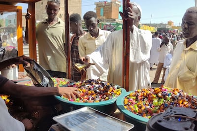 Sudanese men shop for sweets ahead of Eid Al Fitr in Gedaref city. AFP