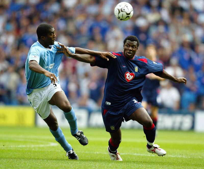 MANCHESTER - AUGUST 23:  Yakubu Ayegbeni (right) of Portsmouth tries to reach the ball ahead of Sylvain Distin (left) of Manchester City during the FA Barclaycard Premiership match held on August 23, 2003 at the City of Manchester Stadium, in Manchester, England. The match ended in a 1-1 draw. (Photo by Ross Kinnaird/Getty Images)