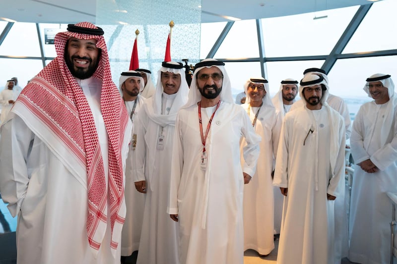 YAS ISLAND, ABU DHABI, UNITED ARAB EMIRATES - November 25, 2018: HRH Mohamed bin Salman bin Abdulaziz, Crown Prince, Deputy Prime Minister and Minister of Defence of Saudi Arabia (L), HH Sheikh Mohamed bin Rashid Al Maktoum, Vice-President, Prime Minister of the UAE, Ruler of Dubai and Minister of Defence (C), HH Sheikh Khalifa bin Tahnoon bin Mohamed Al Nahyan, Director of the Martyrs' Families' Affairs Office of the Abu Dhabi Crown Prince Court (2nd L) and other dignitaries, attend the final day of the 2018 Formula 1 Etihad Airways Abu Dhabi Grand Prix, in Shams Tower.

( Ryan Carter / Ministry of Presidential Affairs )
---