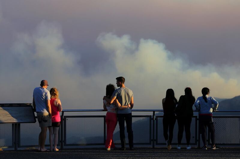 People watch as smoke from the Green Wattle Creek fire is seen from Echo Point lookout in Katoomba, as bushfires continue to blaze in New South Wales, Australia. Reuters