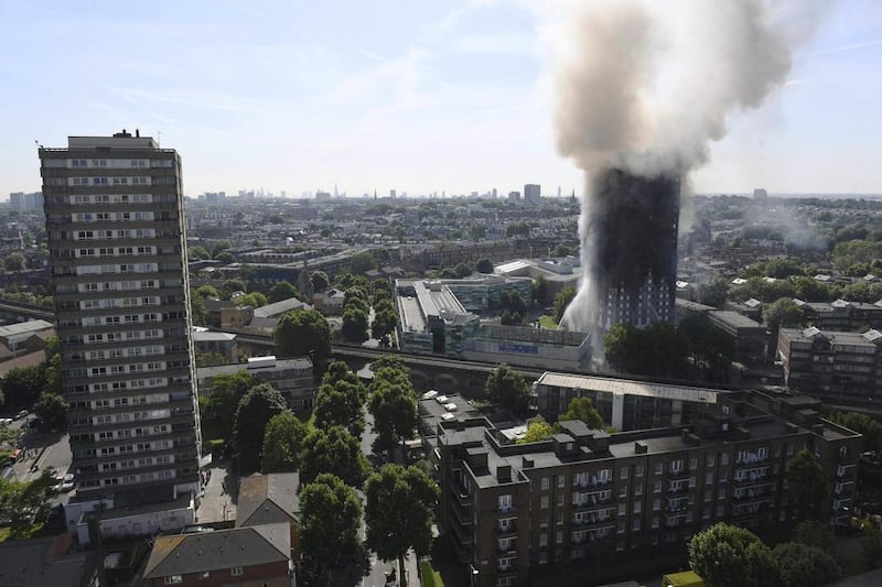 Smoke billows from a fire that engulfed the 24-storey Grenfell Tower in west London on June 14, 2017 as fire swept through a high-rise apartment building in west London killing at least 12 people and injuring dozens. Victoria Jones/PA via AP