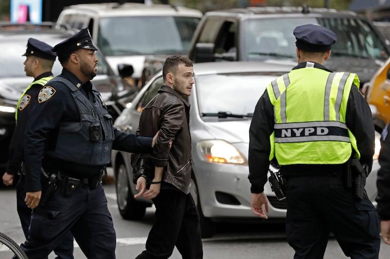 New York police detain an Israeli supporter during the demonstration. EPA