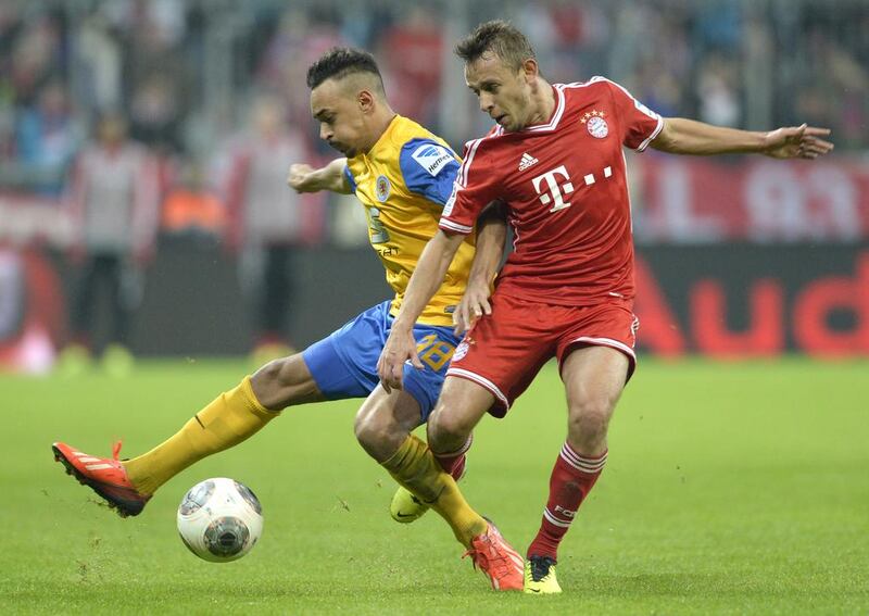 Rafinha, right, has seen his star rise at Bayern Munich this season. Christof Stache / AFP