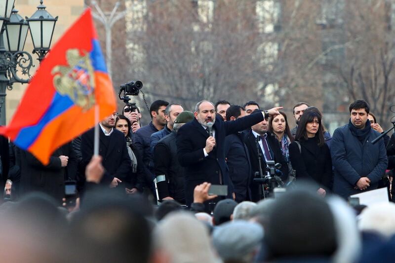 Armenian Prime Minister Nikol Pashinyan gestures speaking to a crowd in the center of Yerevan, Armenia. Armenia's prime minister has spoken of an attempted military coup after facing the military's General Staff demand to step down. The developments come after months of protests sparked by the nation's defeat in the Nagorno-Karabakh conflict with Azerbaijan. AP