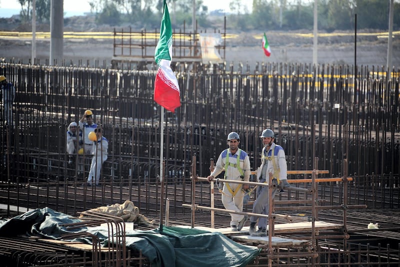 A picture taken on November 10, 2019, shows workers on a construction site in Iran's Bushehr nuclear power plant during an official ceremony to kick-start works for a second reactor at the facility. - Bushehr is Iran's only nuclear power station and is currently running on imported fuel from Russia that is closely monitored by the UN's International Atomic Energy Agency. (Photo by ATTA KENARE / AFP)