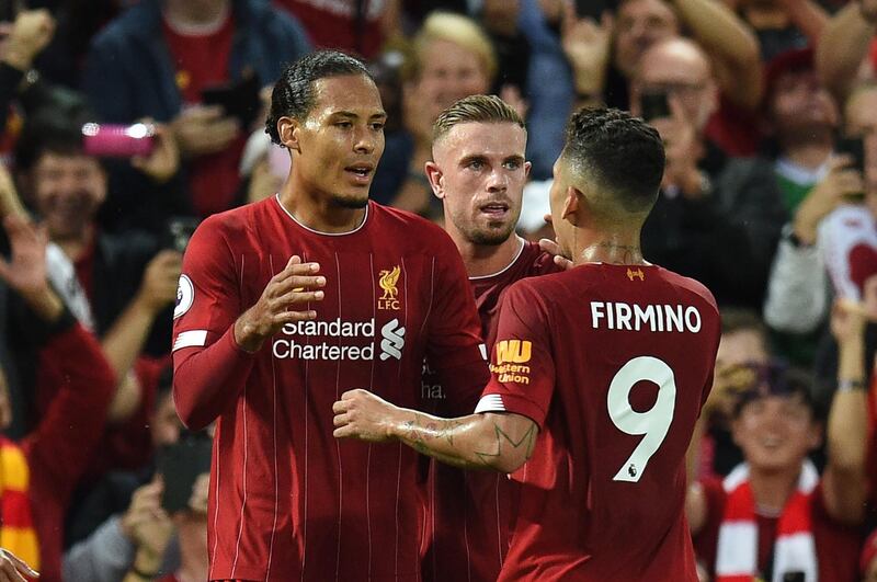 Virgil van Dijk celebrates with teammates after scoring Liverpool's third goal. AFP