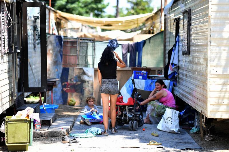 Members of the Roma community are pictured at the "River Village" Roma camp, managed by the Onlus Isola Verde association on June 19, 2018, on the outskirts of Rome. Italy's far-right Interior Minister Matteo Salvini on June 19, 2018 defended his plans to count the Roma community living in the country and deport those without legal status, despite outrage at home and abroad.
 / AFP / Alberto PIZZOLI
