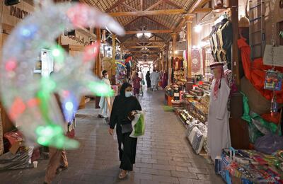 Ramadan-inspired decorations hang at a market in Dubai in the United Arab Emirates as people shop ahead of the Muslim fasting month, on April 12, 2021.  / AFP / Karim SAHIB
