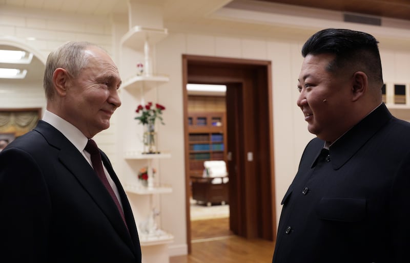 Mr Putin and Mr Kim arrive for their talks. EPA / Sputnik / Kremlin pool