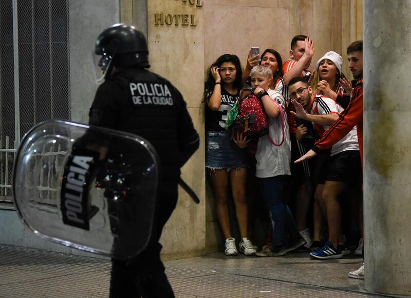 River Plate fans hide from the police during Copa Libertadores victory celebrations in Buenos Aires. AP