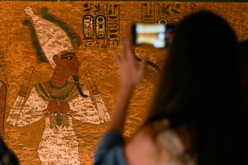 A tourist takes photos inside the tomb chamber of King Tutankhamun in the Valley of the Kings in Luxor. AP Photo