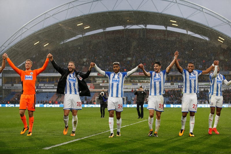 Soccer Football - Premier League - Huddersfield Town vs Manchester United - John Smith's Stadium, Huddersfield, Britain - October 21, 2017   Huddersfield Town���s Jonas Lossl, Laurent Depoitre, Steve Mounie, Christopher Schindler and Mathias Jorgensen celebrate in front of the fans at the end of the match    Action Images via Reuters/Ed Sykes    EDITORIAL USE ONLY. No use with unauthorized audio, video, data, fixture lists, club/league logos or "live" services. Online in-match use limited to 75 images, no video emulation. No use in betting, games or single club/league/player publications. Please contact your account representative for further details.