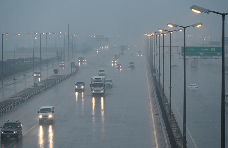 Vehicles drive in a flooded street following heavy rain in Kuwait City. EPA