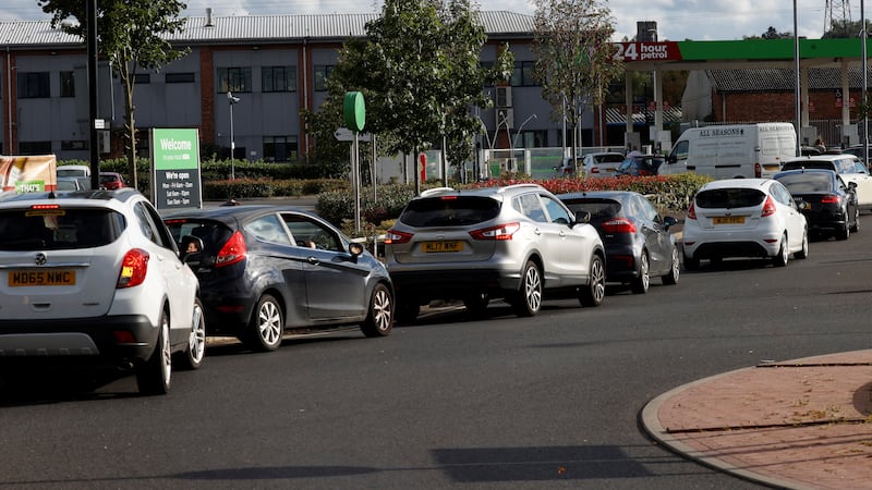 Motorists queue for fuel at a supermarket filling station in Manchester, England. Photo: Reuters