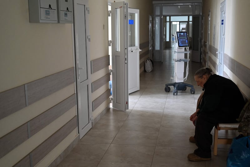 A mother of a wounded Ukrainian serviceman waits outside his ward in a hospital in Kyiv. AFP