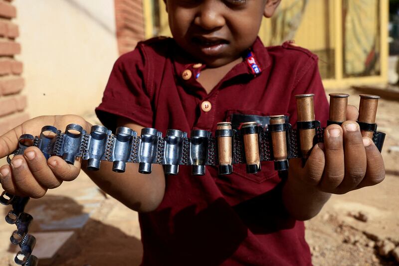 A boy holds bullet cartridges as clashes between the RSF and the army continue in Khartoum on May 13. Reuters
