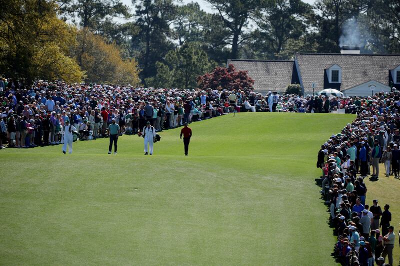 Spain's Jon Rahm and Woods of the US  walk down the fairway during the final round at the Masters tournament in Georgia. Reuters