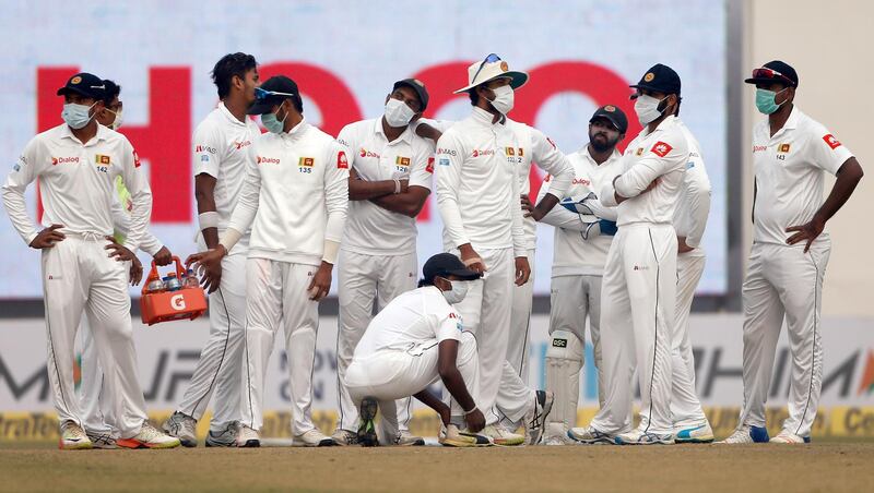 Sri Lankan players get together as they wait for third umpire decision for the wicket of India's Ajinkya Rahane during the fourth day of their third test cricket match in New Delhi, India. Altaf Qadri / AP Photo