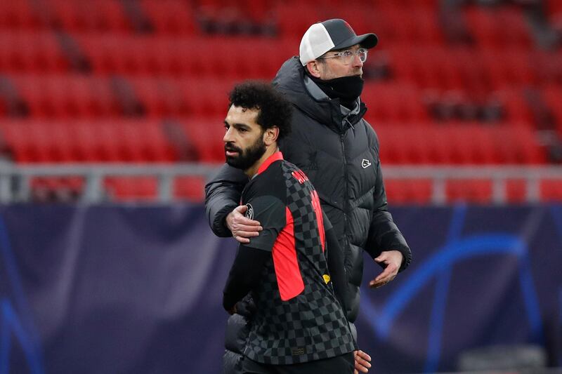 Liverpool manager Jurgen Klopp hugs Liverpool's Mohamed Salah as he walks off the pitch. AP
