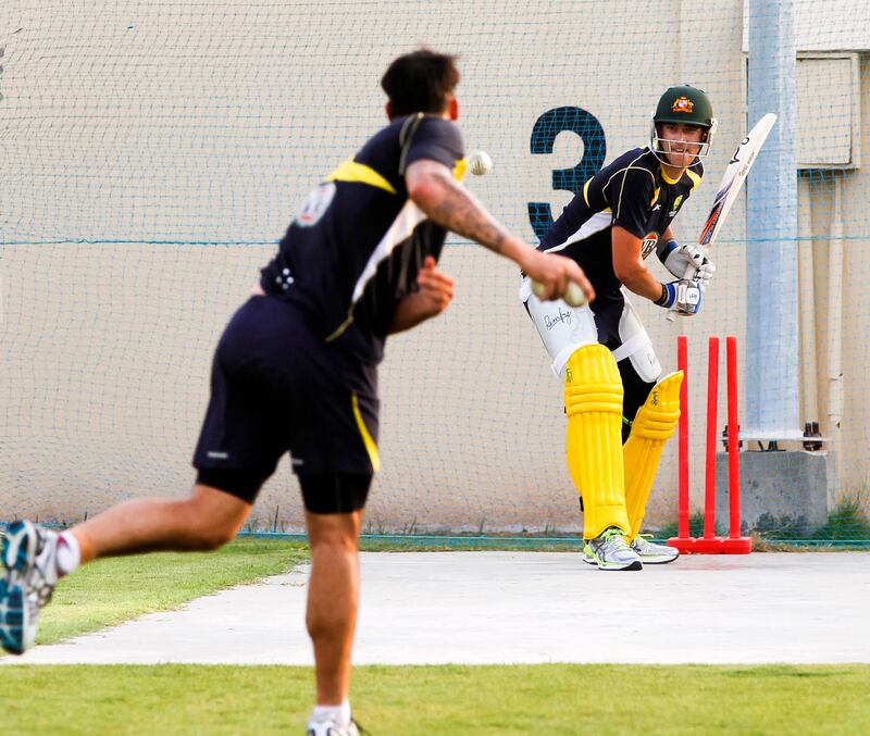 Australian batsman Michael Starc, right, receives a ball during a training session at the Sharjah Cricket Stadium in Sharjah, United Arab Emirates, Thursday, Aug. 23, 2012. Australia plays Afghanistan in Sharjah on Saturday, Aug. 25, 2012. (AP Photo/Charles Verghese) *** Local Caption ***  Mideast Emirates Australia Afghanistan Cricket.JPEG-05fcd.jpg