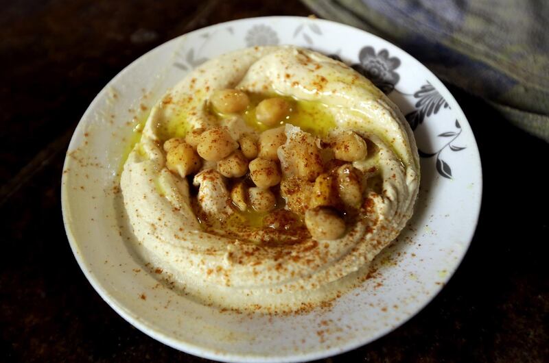 A plate of Hummus is served  at a restaurant in the Lebanese coastal city of Tripoli, north of Beirut on October 20, 2014. Hummus is a Levantine food dip or spread made from mashed chickpeas blended with tahini, olive oil, lemon juice, salt and garlic. Today, it is popular throughout the Middle East, North Africa, and in Middle Eastern cuisine around the globe. AFP PHOTO/JOSEPH EID (Photo by JOSEPH EID / AFP)
