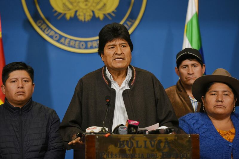 In this photo provided by the Agencia Boliviana de Informacion, Bolivian President Evo Morales speaks from the the presidential hangar in El Alto, Bolivia, Sunday, Nov. 10, 2019. Bolivia's military chief Gen. Williams Kaliman said that President Evo Morales should resign so that stability can be restored after weeks of protests over his disputed election. He stepped in after Morales agreed earlier in the day to hold a new election. (Enzo De Luca/Agencia Boliviana de Informacion via AP)