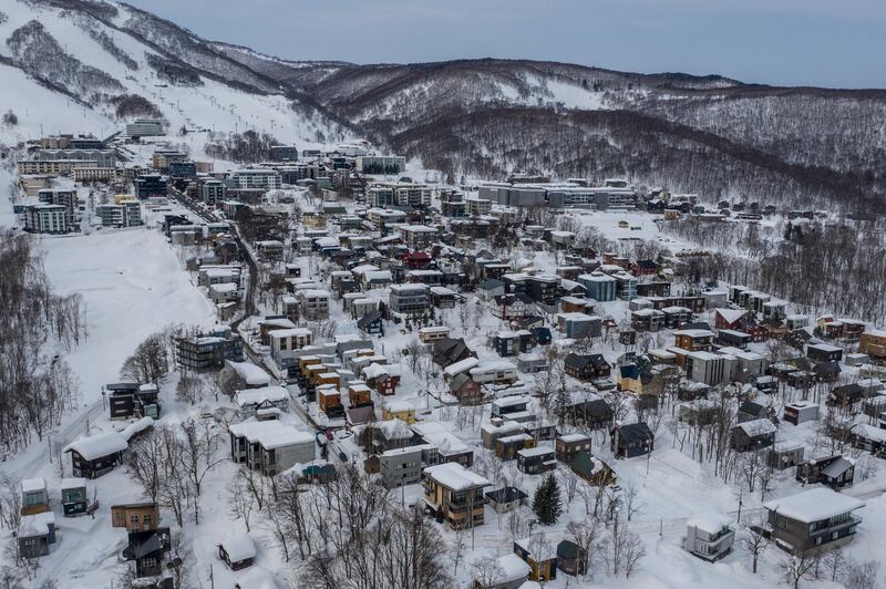 NISEKO, JAPAN - JANUARY 28: In this drone photograph, snow covers mostly empty luxury holiday homes on January 28, 2021 in Niseko, Japan. As one of Asias most popular ski resorts, Niseko usually welcomes huge numbers of foreign tourists each winter, with around 85 percent coming from abroad. However, as the Covid-19 coronavirus pandemic continues to halt almost all foreign travel, the resort, like many other tourist destinations in Japan, has seen a huge drop in visitor numbers which is putting a significant financial burden on local businesses with many having to close, at least temporarily. (Photo by Carl Court/Getty Images)