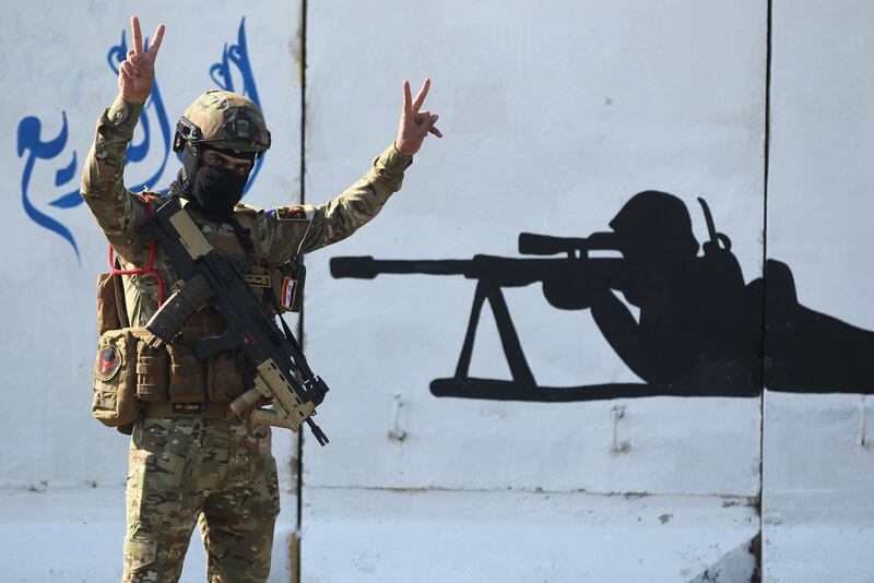 A member of Iraq's rapid response military unit takes part in celebrations at Baghdad's International Airport. AFP