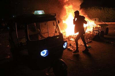 Burning tyres light up the night skies during anti-government protests in the Shiite shrine city of Karbala, south of Iraq's capital Baghdad, late on October late October 28, 2019. Protests have persisted across Iraq and its Shiite-majority south, with night-time rallies in the central city of Karbala spiralling into skirmishes with security forces.  / AFP / -
